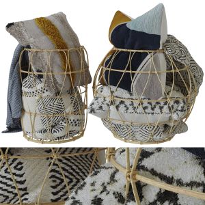 Bamboo Basket With Decorative Pillows And A Blanke